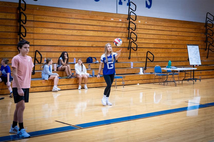 Students play volleyball in PE